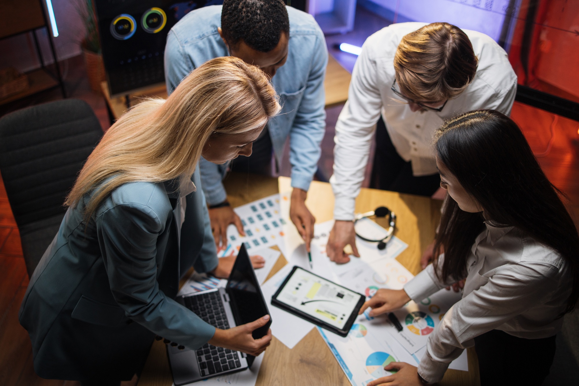 Multiracial business partners analysing graphs at office